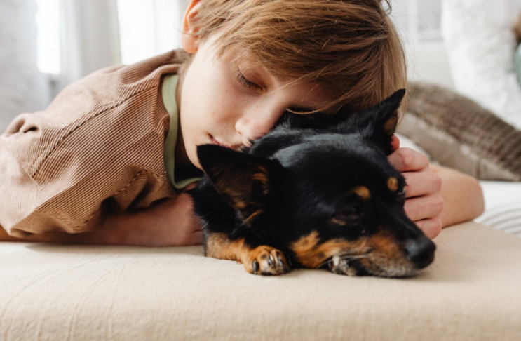 Little kid sleeping with their dog